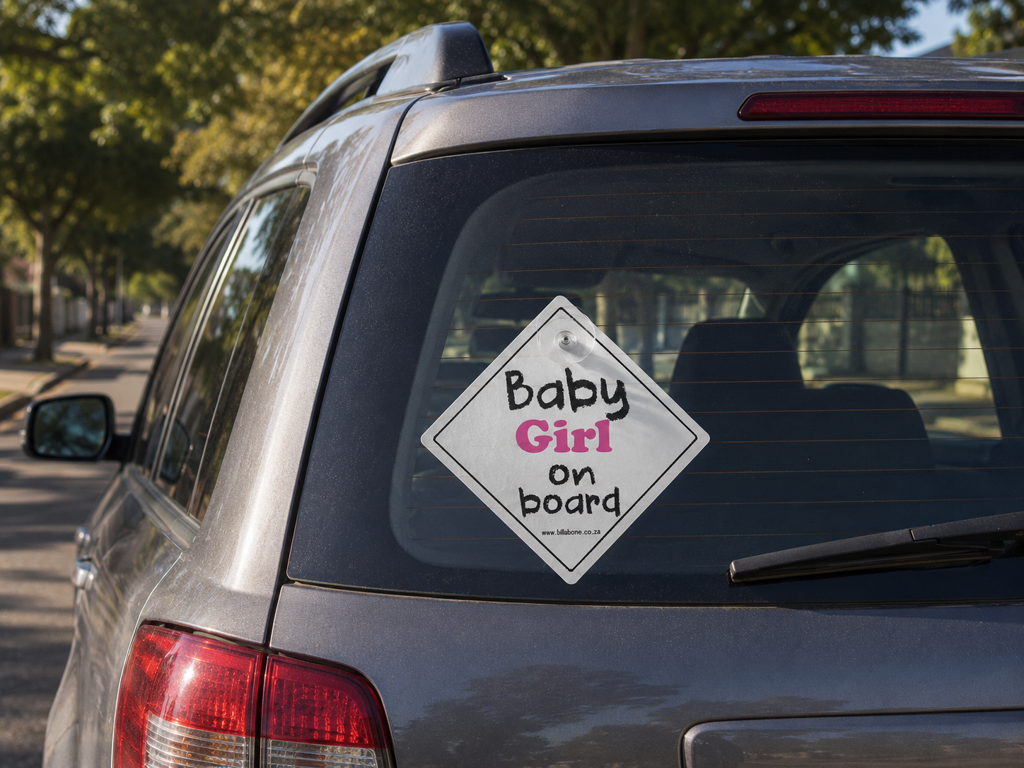 Rear view of SUV displaying Baby Girl on Board sign by Billabone