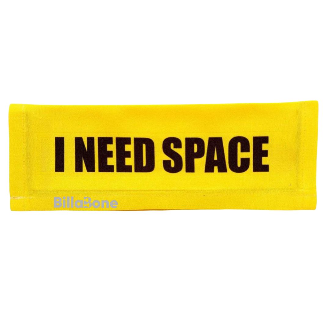 A yellow leash cover with bold black text "I Need Space," featuring the Billabone logo. This leash cover is designed for dogs that are either anxious, unwell, elderly, nervous, adopted, or in training, helping ensure their need for space is respected during walks or outings.