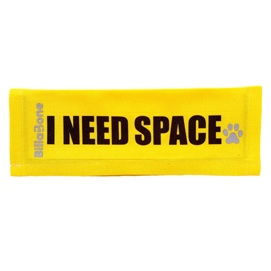 A yellow leash cover with bold black text "I Need Space," featuring the Billabone logo and a paw print icon. This leash cover is designed for dogs that are either anxious, unwell, elderly, nervous, adopted, or in training, helping ensure their need for space is respected during walks or outings.