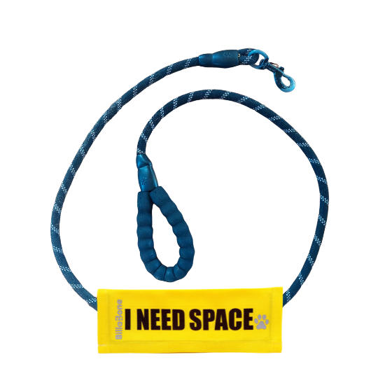 A yellow leash cover with bold black text "I Need Space," featuring the Billabone logo and a paw print icon. This leash cover is designed for dogs that are either anxious, unwell, elderly, nervous, adopted, or in training, helping ensure their need for space is respected during walks or outings.