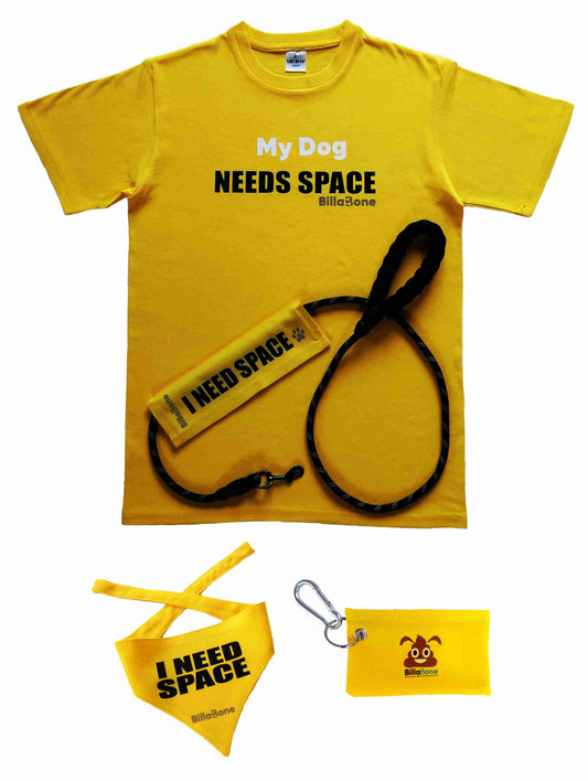 A vibrant yellow dog accessory set by Billabone, featuring a t-shirt with "My Dog Needs Space" text, a matching leash cover, a triangular bandana, and a compact poop bag holder. Perfect for dog owners managing pets who are anxious, unwell, elderly, nervous, adopted, or in training, this set promotes awareness while adding functionality and style.